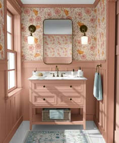 a bathroom with pink walls and floral wallpaper on the walls, along with two sinks