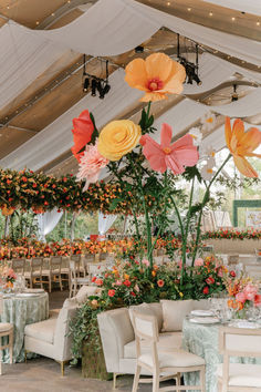 the tables are decorated with flowers and greenery