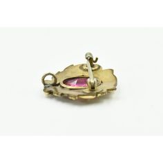 A fantastic example of the Art Nouveau period - this piece has an ornate floral raised design with a bezel set faceted piece of pink glass.  The back has a lever pin closure as well as a bale so it can be worn as a pendant or with a another piece hanging from the brooch.  The Art Nouveau (literally “New Art”) era, lasting from 1890 to 1910, overlapped with the Edwardian and Victorian eras and was relatively brief, though it made a lasting contribution to the meaning of magnificent jewelry.  .  D Antique Pink Brooch Jewelry, Antique Pendant Brooches With Gemstone, Floral Art Nouveau, Art Eras, Pink Glass, The Meaning, Victorian Era, Bezel Setting, Floral Art