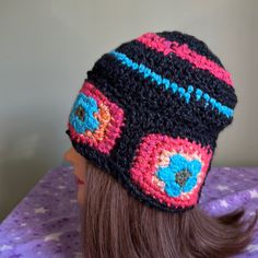 a crocheted hat on top of a doll head