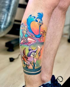 a man's leg with tattoos on it and an image of sonic the hedgehog