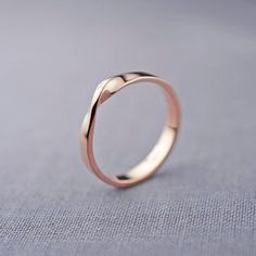 a silver ring on a gray surface