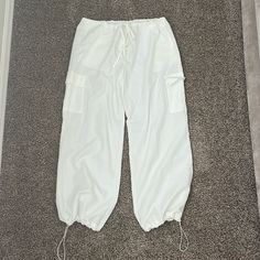 Nwot Never Worn. White Balloon Pants From Cider. Cinch Waist And Cinch Around Ankles. Wide Leg Pants. They Are Pretty See Through. Size Xxs But Run Very Very Big. White Baggy Drawstring Pants, White Drawstring Ankle-length Bottoms, White Cargo Pants With Elastic Waistband For Loungewear, Casual White Parachute Pants With Elastic Waistband, Casual White Bottoms With Drawstring, Casual White Drawstring Bottoms, White Ankle-length Bottoms With Cargo Pockets, White Cargo Pants With Side Pockets For Loungewear, White Ankle-length Cargo Bottoms