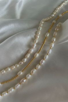 rice pearls | pearls | beads | seed beads | gold beads | gold bracelets | white seed beads | handmade | jewelry | trendy | aesthetic | affordable | beachy | tropical | fashion | accessories | summer | tiktok | small business | isabelles jewelry | clean girl | silk | satin | white | freshwater | summer | 2023 | pearl | gemstones | gem | instagram | etsy | small business | miami | coastal | Clean Girl Necklace, Pearl Choker With Round Beads, Pearl Chain Choker With Round Beads, Pearl White Beaded Choker, Crocette Aesthetic, Bead Bracelets Aesthetic, Freshwater Pearl Jewelry Handmade, Cleangirl Outfit, Clean Girl Jewelry