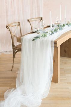 a long table with candles and flowers on it is set up for a wedding reception