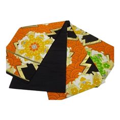 three pieces of fabric with designs on them, one is orange and the other is black