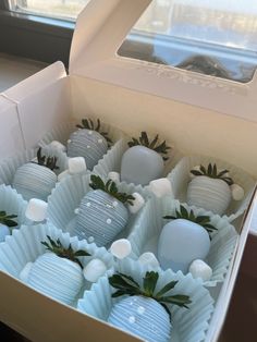 a box filled with white chocolate covered strawberries