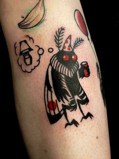 a tattoo with an image of a bird holding a hot dog