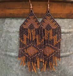 Aztec design long fringe beaded earrings.  1 1/2" wide x 4" long (from top of the hook to the longest fringe) Brown Beaded Earrings With Fringe, Brown Beaded Fringe Dangle Earrings, Artisan Fringe Tassel Dangle Earrings, Brown Dangle Beaded Earrings With Fringe, Brown Fringe Dangle Beaded Earrings, Artisan Tassel Dangle Earrings With Fringe, Artisan Dangle Tassel Earrings With Fringe, Fringe Beaded Earrings, Beaded Fringe Earrings