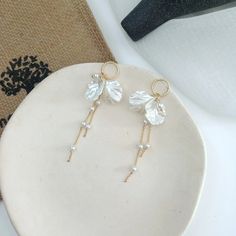 Check out our bow shaped pearl tassel earrings. Such an elegant pair of earrings, that would be perfect for just the right outfit. Elegant Dangle Tassel Earrings For Pierced Ears, Chic White Earrings With Pearl Chain, Elegant Tassel Dangle Earrings For Pierced Ears, Chic White Pearl Chain Earrings, Chic White Pearl Earrings With Pearl Chain, Elegant Pearl Drop Tassel Earrings For Party, Elegant Evening Tassel Drop Earrings, Party Tassel Pearl Drop Earrings, Party Tassel Drop Earrings With Pearl Detail