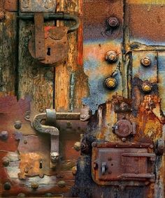 an old rusty door with rusted metal latches and knobs on the outside