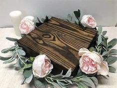 a wooden box decorated with flowers and greenery