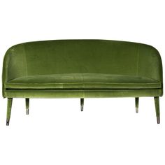 a green velvet sofa with metal legs