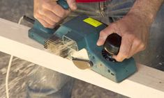 a man using a power tool on a piece of wood