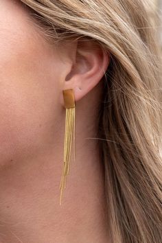 Our Tatiana Earrings, featuring a gold tassel dangle, are coming in hot, and they are going to be your new faves! They're ultra lightweight, so you can wear them all day and night without feeling weighed down - but trust us, they still pack a punch. You'll feel like you're walking down the runway every time you wear them. The playful tassel sways with every movement and adds just the right amount of flirtatious fun to your look.18k gold-plated stainless steelHypoallergenicTarnish resistantWaterp Long Gold Earrings, 18k Gold Jewelry, Light Weight Earrings, Stainless Steel Earrings, Day And Night, In Hot, Holiday Outfits, Plus Size Fashion, Gold Earrings