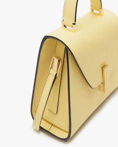 Valextra Iside Mini Solid in Vaniglia Envelope flap top with turn-lock closure Rolled top handle Detachable shoulder strap Interior card slot Gold hardware Leather outer Signature hand-painted, black lacquered Costa edges 7.7”W x 5.5” H x 3.7”D Made in Italy Elegant Yellow Satchel With Gold-tone Hardware, Luxury Yellow Satchel For Office, Modern Yellow Shoulder Bag For Formal Occasions, Luxury Yellow Satchel For Formal Occasions, Yellow Luxury Satchel For Formal Occasions, Formal Yellow Satchel With Detachable Strap, Luxury Yellow Formal Satchel, Elegant Yellow Bag For Work, Elegant Yellow Workwear Bag