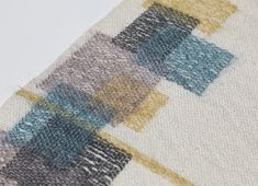 a close up view of a rug with different colors and shapes on it's surface