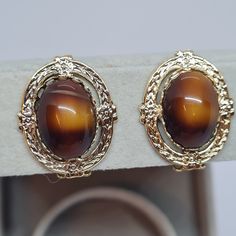 Vintage oval clip-on earrings. Gold-tone textured metal with brown art glass cabochon clip earrings. Clips size: 2.8x2.2 cm/1.1x0.9 inches. Mark: unsigned. Condition: perfect vintage. Maybe you want to see other clip-on earrings too: https://www.etsy.com/shop/VintageVoyageLT?ref=seller-platform-mcnav&section_id=32074139 You can write me a message if you have any questions. Glad you visited my store! Have a great time! Elegant Oval Cabochon Clip-on Jewelry, Gold Clip-on Jewelry With Oval Cabochon, Luxury Gold Cabochon Clip-on Earrings, Gold Oval Cabochon Clip-on Earrings, Clip-on Oval Cabochon Earrings For Gifts, Luxury Oval Vintage Clip-on Earrings, Brown Art, Clip On Earrings, Gold Earrings