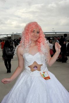 a woman with pink hair wearing a white dress