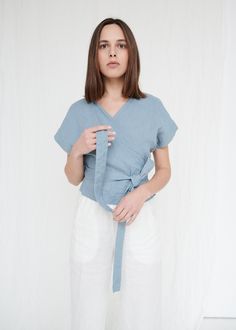 "SIZING & FIT This garment is true to size, and we recommend choosing the size you usually wear. If you want the garment to be loose-fitting, choose a larger size than you usually wear. Before placing an order, check the approximate measurements of the finished garment given below. Model is 5′6″ (170cm) tall with an 80cm/31″ bust, 68cm/26″ waist, 91cm/35″ hip, and she is wearing an XS in dusty blue. XS Length ± 50cm | 19.7\" Bust ± 96cm | 37.8\" Sleeve length from neckline ± 23cm | 9.1\" Sle Blue Linen V-neck Blouse, Blue Linen Blouse For Spring, Spring Blue Linen Blouse, Spring Short Sleeve Linen Top, Spring Linen Short Sleeve Top, Blue Linen Short Sleeve Top, Blue Linen Tops For Spring, Versatile V-neck Linen Tops, Versatile Relaxed Fit Linen Top