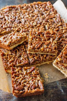 pecan bars cut into squares and stacked on top of each other, ready to be eaten