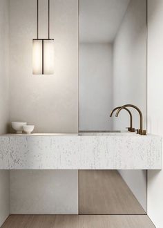 a bathroom sink sitting under a mirror next to a wall mounted faucet in a bathroom