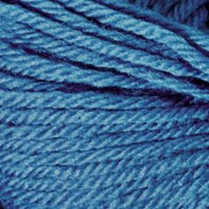 blue skeins of yarn are shown in this close up photo, with the light shining