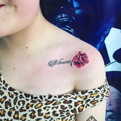 a woman with a rose tattoo on her chest