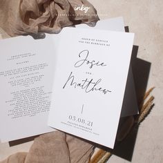 an open wedding program on top of a table next to some flowers and cloths