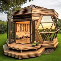 a wooden gazebo sitting on top of a lush green field