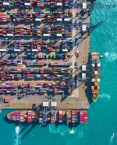 an aerial view of shipping containers in the ocean