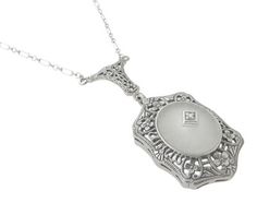 This romantic Art Deco drop pendant diamond filigree necklace in sterling silver is awash in wonderful intricate detail and is the perfect piece to collect, wear and enjoy. At its center is a 0.005 carat securely four prong set single cut diamond atop a lovely frosted cabochon sun ray camphor crystal, bezel set in a beautiful frame of filigree flowers, leaves, overscored with light scattering millgrain beadwork. A large elegant scroll floral filigree bail is attached to the classic 18 inch long Gatsby Jewelry, Diamond Drop Pendant, Filigree Necklaces, Filigree Jewelry, Drop Pendant Necklace, Art Deco Necklace, Silver Jewellery Sets, Crystal Diamond, Romantic Art