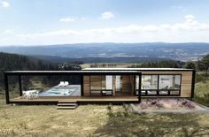 a small house on top of a hill with a hot tub in the back ground