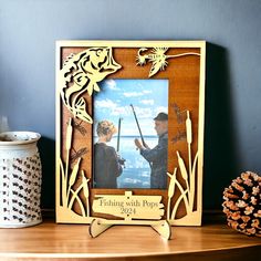 a wooden frame with an image of two people holding fishing rods