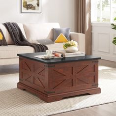 a living room with a couch, coffee table and other items on the carpeted floor