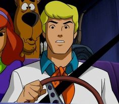 scooby and friends driving in a car with the driver looking at the camera