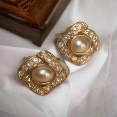 "Vintage Faux Pearl Clip Earrings, Small Elegant Earrings, Rhinestone Earrings, Wedding Jewelry, Wedding Earrings, Jewelry for Bride Vintage Faux Pearl Clip Earrings Gold Tone Metal with faux pearl center surrounded by clear rhinestones Clip style earrings with comfort pads Small dainty earrings measuring .75\" x '75\" Very good condition, all stones intact Comes in a box ready for gift giving For more vintage items visit www.secondactshop.etsy.com Follow me on Instagram @ secondactshop for new Antique Clip-on Pearl Earrings For Wedding, Vintage Pearl Drop Clip-on Earrings, Jewelry For Bride, Vintage Pearl Clip-on Earrings, Vintage Pearl Clip-on Earrings For Gift, Vintage White Pearl Clip-on Earrings, Bride Vintage, Earrings Wedding, Vintage Bride