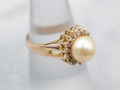 Champagne all around! These gorgeous stones perfectly compliment each other. The warm-hued champagne pearls are accented by a halo of champagne diamonds. This ring is ready to be dressed up or down!Metal: 14K Yellow GoldGem: PearlGem Measurements: 7.8 mm, RoundAccents: 15 Diamonds totaling .30 Carats, I1 in Clarity, Champagne in ColorRing Size: 6.25Marks: "14K" Stamped on the inside band Champagne Pearl Ring, Elegant Gold Halo Pearl Ring, Champagne Diamond Cluster Ring, Champagne Colored Diamond Rings, Champagne Ring, Diamond Halo Ring, Rose Gold Band, Champagne Diamond, Halo Diamond Ring