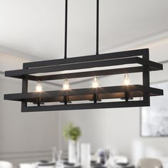 a rectangular light fixture hanging over a dining room table