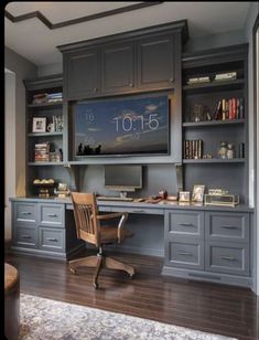 a home office with built in desk and bookcases