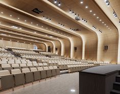 an empty auditorium with rows of chairs and a podium