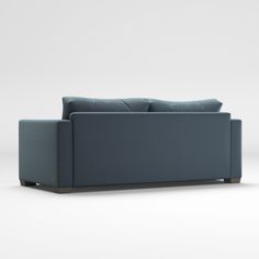 a blue couch sitting on top of a white floor