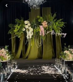 an image of a wedding stage setting with flowers and greenery