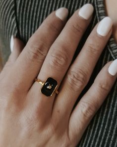 This glossy black Ryker ring features a rectangular shape and a single crystal set in the center. With its sleek and sophisticated design, this ring adds a subtle sparkle to any look. Wear it daily or for special occasions. Waterproof Tarnish resistant 18K Gold plated stainless steel Hypoallergenic Black Ring, Black Rectangle, Crystal Set, Black Rings, Special Occasion, 18k Gold, Sparkle, Plating, Crystals