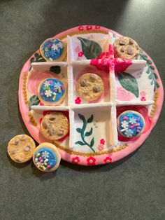 a pink plate topped with cookies on top of a table