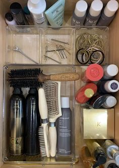 an organized drawer with hair brushes and other items