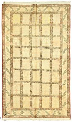 an antique rug with geometric design on the bottom and sides, in cream color tones