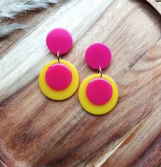 Introducing these fabulous retro drop earrings! Inspired by Pop Art designs from the 1960s, these colour block earrings are sure to make a statement. Handmade in bright pink and yellow resin, these colourful earrings are crafted to create a sleek and modern look. The geometric design adds a touch of sophistication, while the bold design adds a pop of contrast. Perfect for any occasion, these unique earrings are a must-have accessory for those who love to embrace retro vibes with a modern twist. Retro Multicolor Drop Earrings, Retro Yellow Dangle Earrings, Retro Multicolor Jewelry With Matching Earrings, Retro Yellow Dangle Jewelry, Retro Handmade Drop Earrings, Retro Yellow Earrings For Party, Yellow Retro Party Earrings, Retro Yellow Party Earrings, Retro Multicolor Earrings For Parties