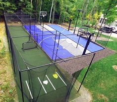 an outdoor tennis court is shown in the middle of a yard with nets and balls on it