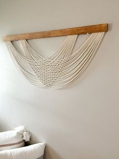 a white bed sitting under a wooden shelf